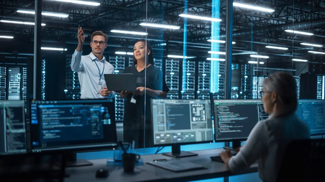 A cybersecurity professional monitoring network security on multiple screens, analyzing potential threats and ensuring data protection.